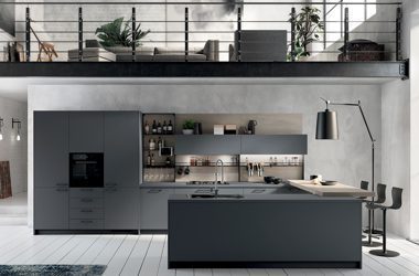 Luxury modern kitchen by Weizter Kitchens featuring dark grey handleless cupboards, a large central kitchen island, integrated appliances and an industrial-style open-plan design.