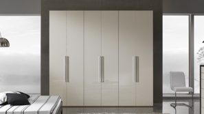 Large built-in bedroom cupboard with four tall doors and vertical handles