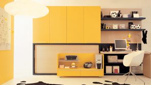 Bright home study with yellow cabinetry, open shelves, desk and white chair