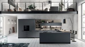 Contemporary kitchen with dark cabinetry and central island under mezzanine