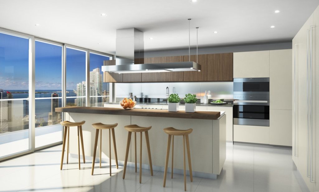 Bright kitchen with large windows, central island, wooden stools and built-in appliances