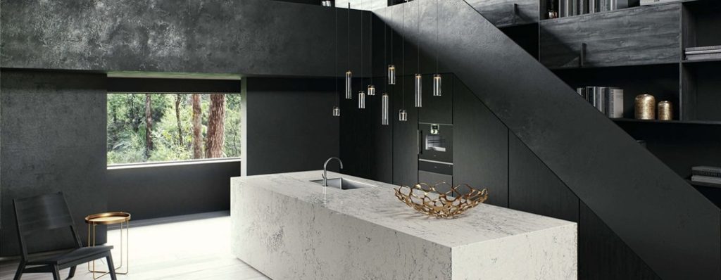 Kitchen interior with large white island and black cabinetry under staircase