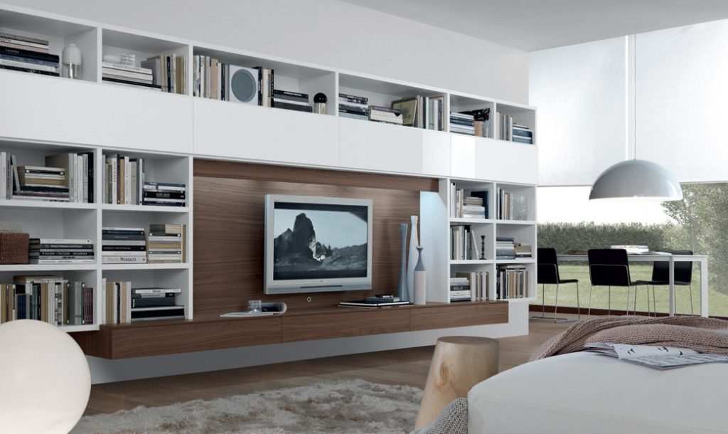 White and wood-finish fitted media unit with shelves, TV, and decorative items in a living room