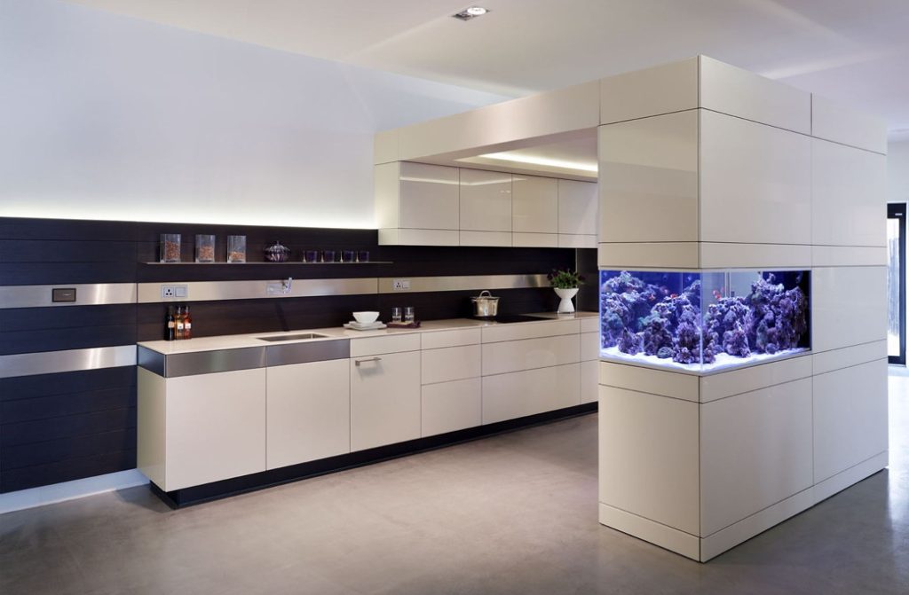 Neutral-toned kitchen with integrated aquarium and sleek cabinetry