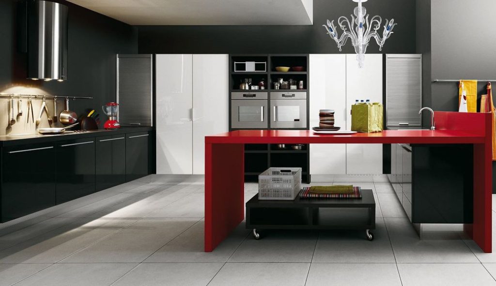Kitchen interior with black and white cabinetry and a red island countertop
