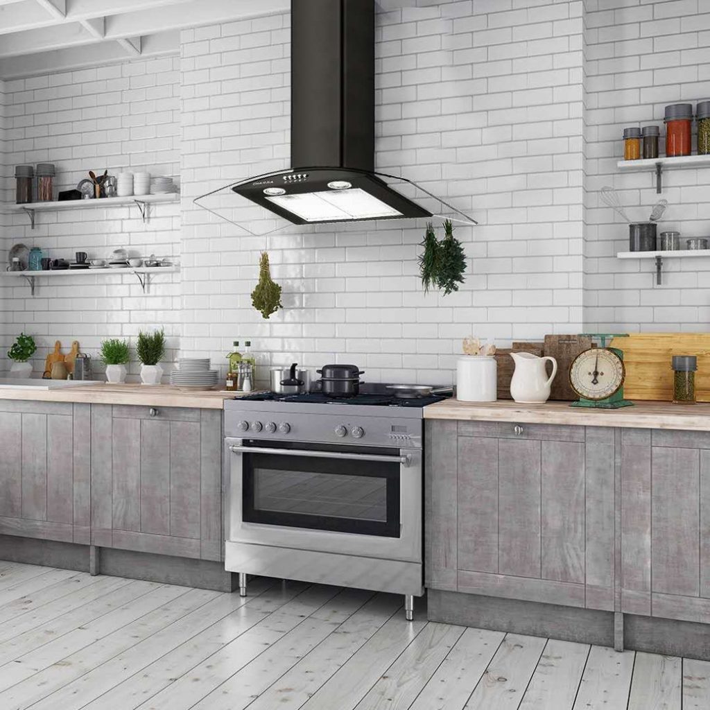 Modern kitchen with stainless steel stove, black extractor fan, grey cabinets and white tiled walls