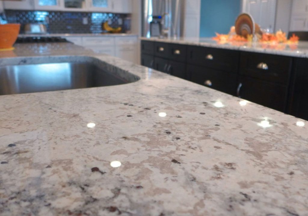 Close-up of a speckled light-coloured kitchen countertop with a built-in sink