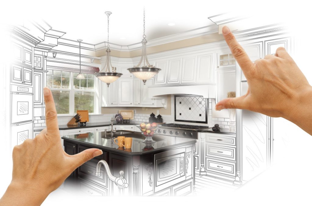 Hands framing a kitchen design sketch transitioning into a finished kitchen with island and pendant lights