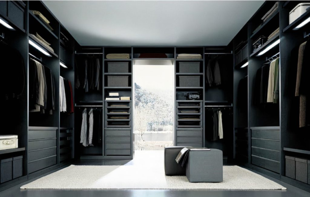 Spacious walk-in wardrobe with black cabinetry and hanging clothes