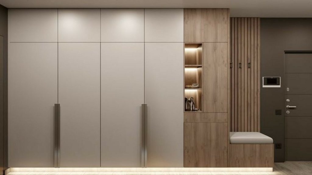 Modern built-in bedroom cupboards with white and wood finishes and integrated lighting