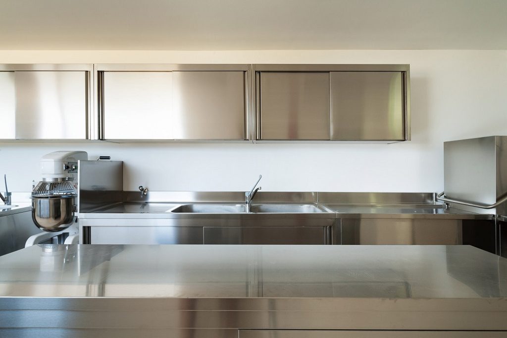 Stainless steel kitchen cabinetry with double sink and mixer tap