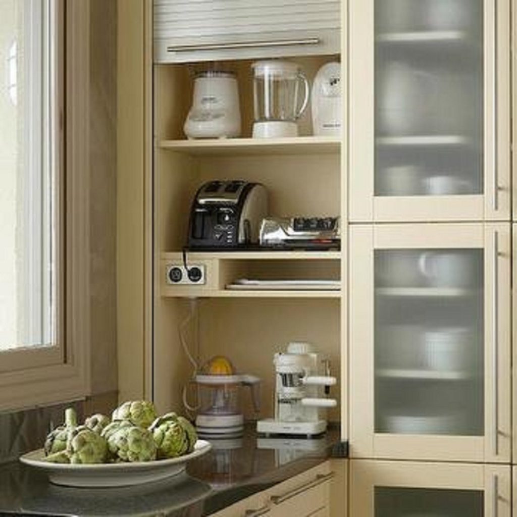 Kitchen cabinetry with appliances and storage shelves next to window