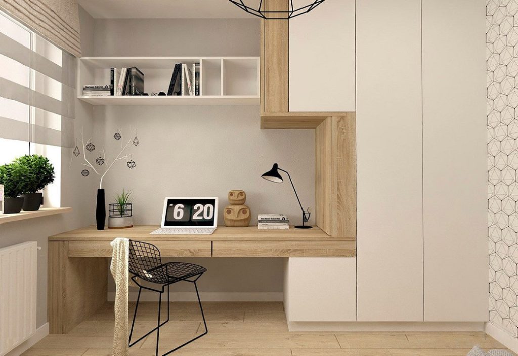 Home office with built-in desk, white shelving, wooden cabinetry and black wire chair