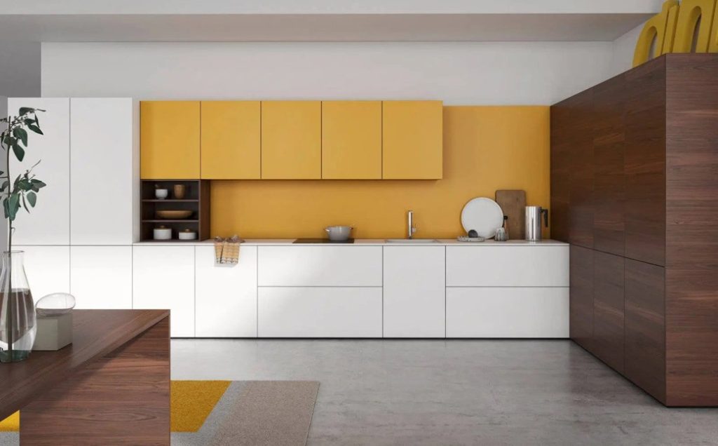 Kitchen with white lower cabinets, yellow upper cabinets, and dark wood tall cupboards