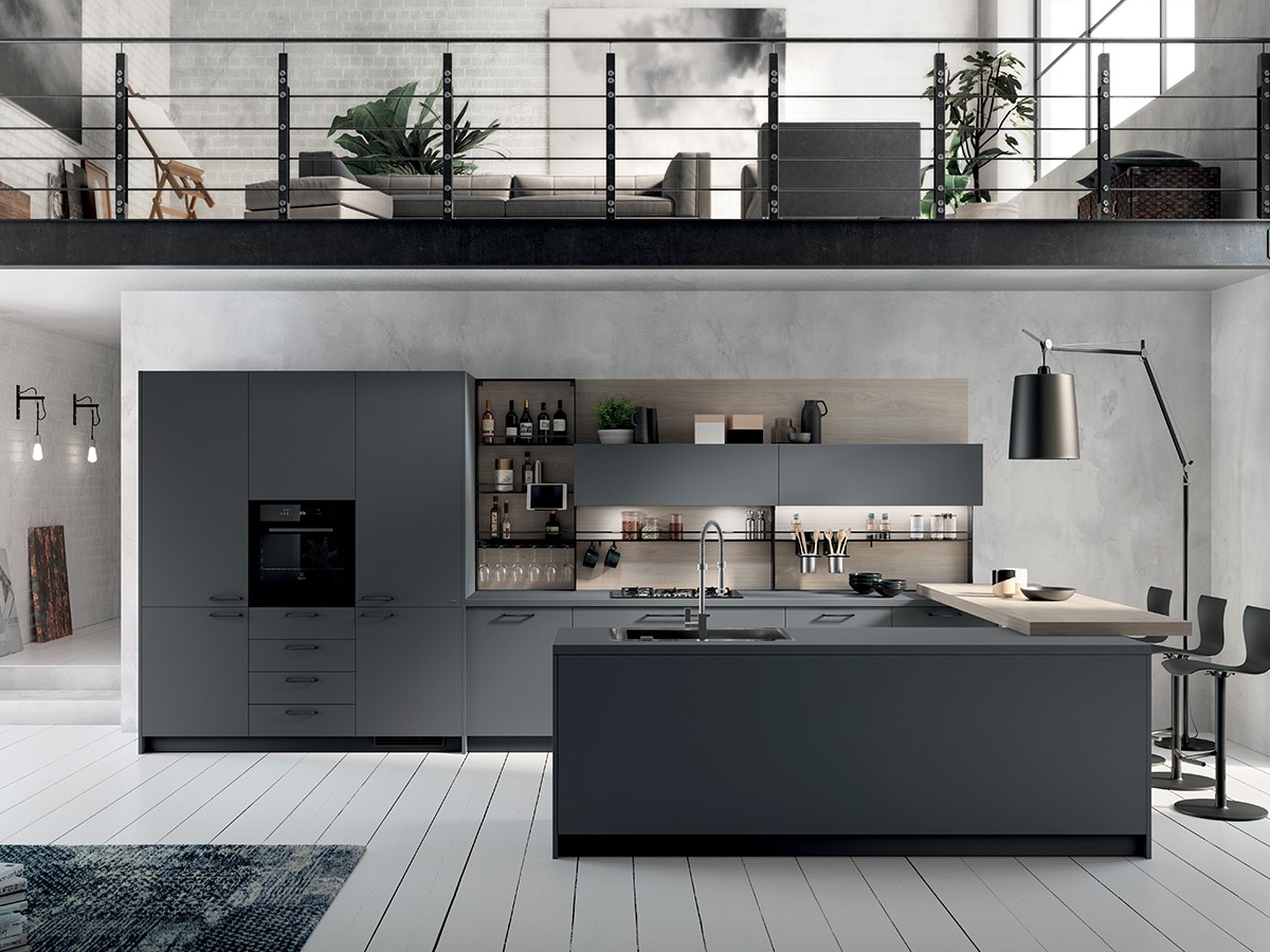 Modern minimalist kitchen with a white island, charcoal floor-to-ceiling cupboards and large windows overlooking a garden.