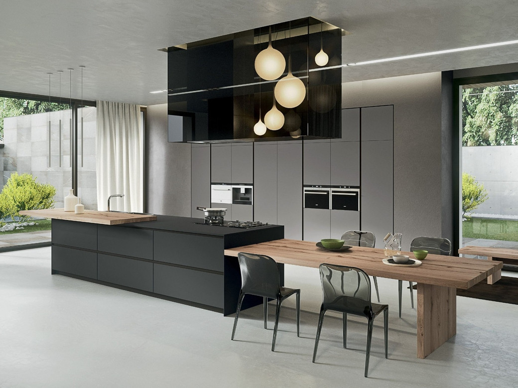Modern kitchen with a black island combined with a wooden dining table and transparent chairs, large windows showing greenery