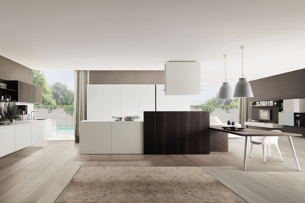 Modern kitchen with white and dark wood island, built-in stove, overhead range, pendant lights, and open-plan living area.