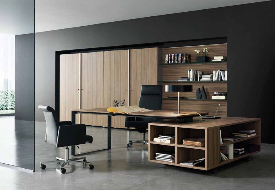 Modern home study with wooden desk, open storage shelves, two black swivel chairs, bookshelves, and large wooden cabinets.
