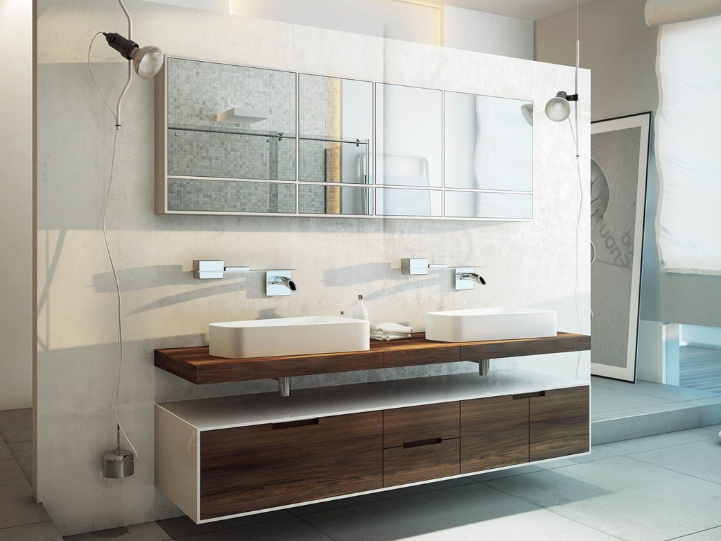 Modern bathroom with a long rectangular segmented mirror above two white vessel sinks on a floating wooden countertop.