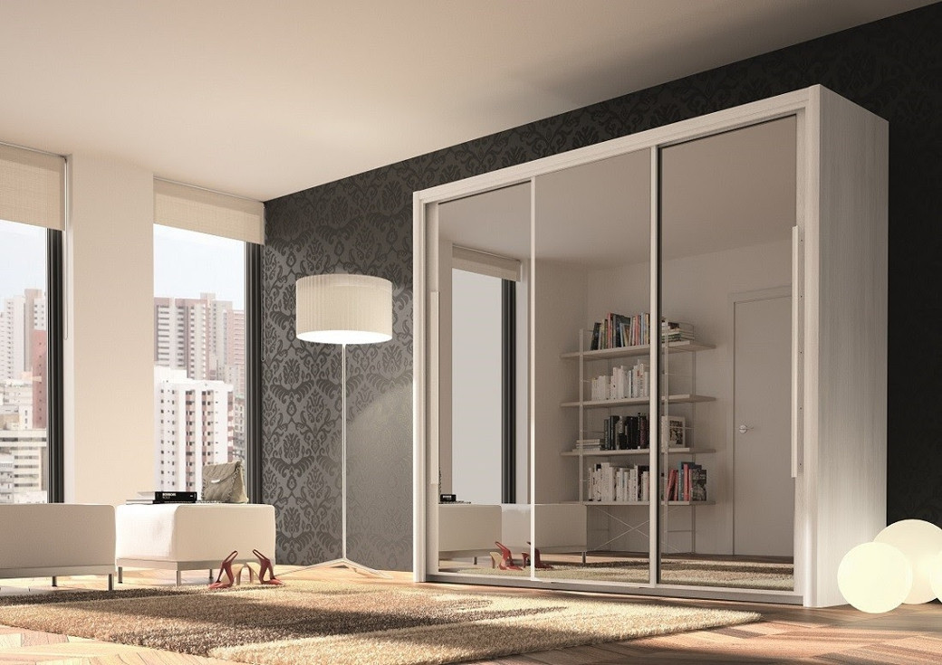Modern room with mirror sliding door wardrobe, floor lamp, white armchair, shoes, and city view windows.