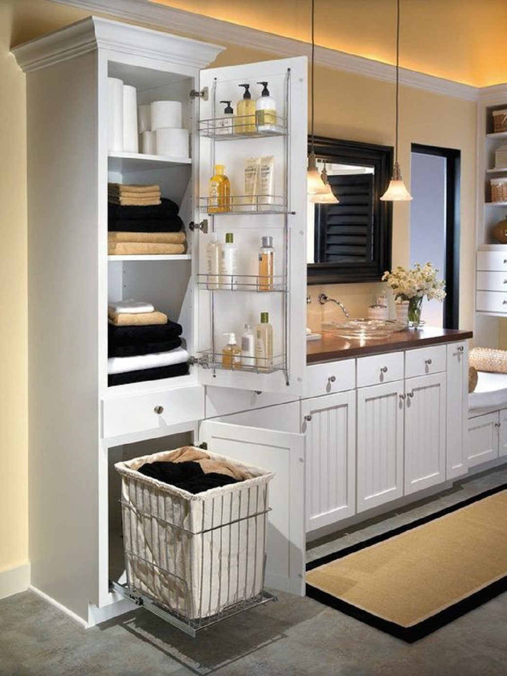 White bathroom cabinet with open door showing shelves stocked with towels and toilet paper, an inside door rack with toiletri
