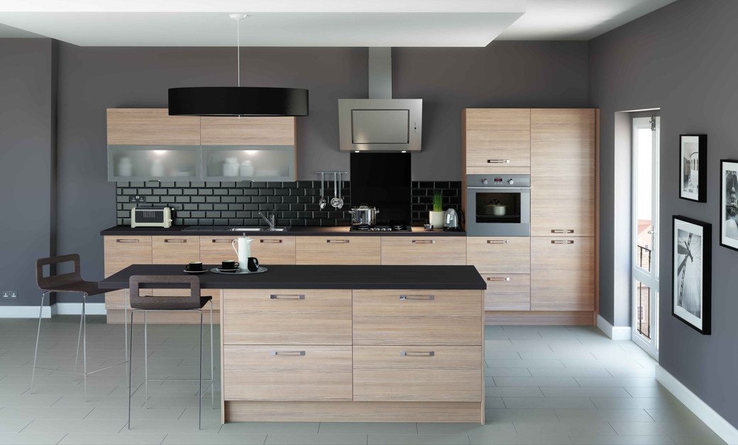 Modern kitchen with light wood cabinets featuring frosted glass panels, black countertops, black tile backsplash, and island.