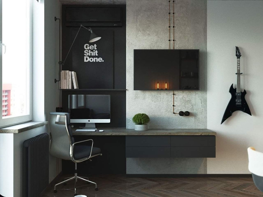 Minimalist home office in small apartment with wall-mounted desk, computer, swivel chair, TV, wall lamp, books, guitar, and m