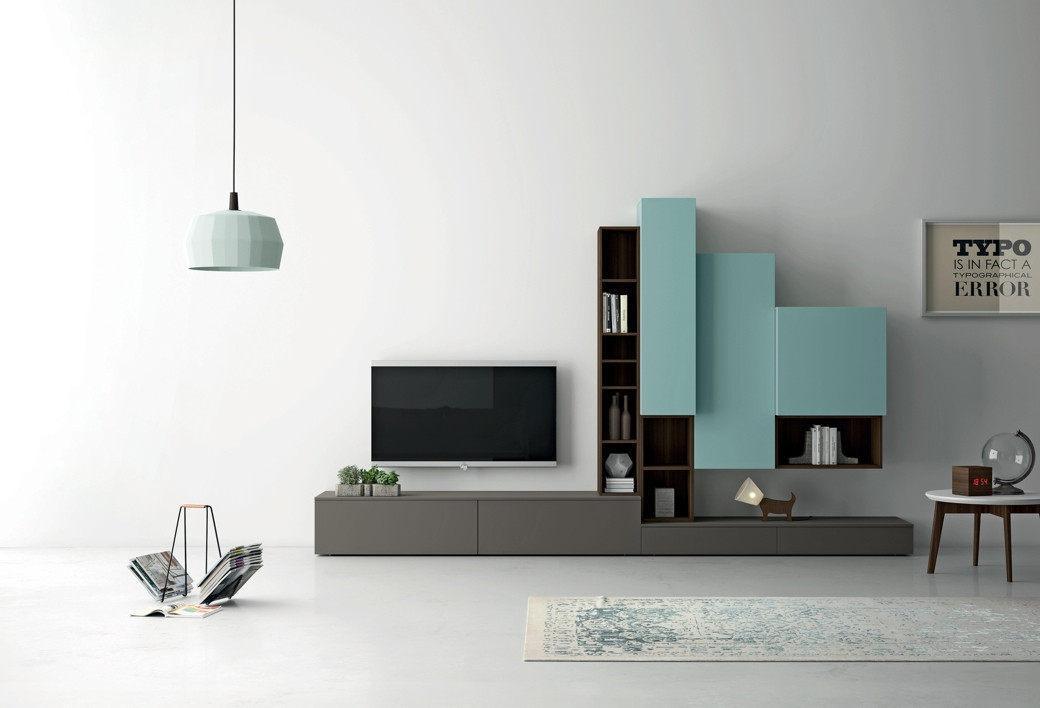 Modern living room with a mounted TV, grey and blue custom storage units, a light blue pendant, and a small side table.