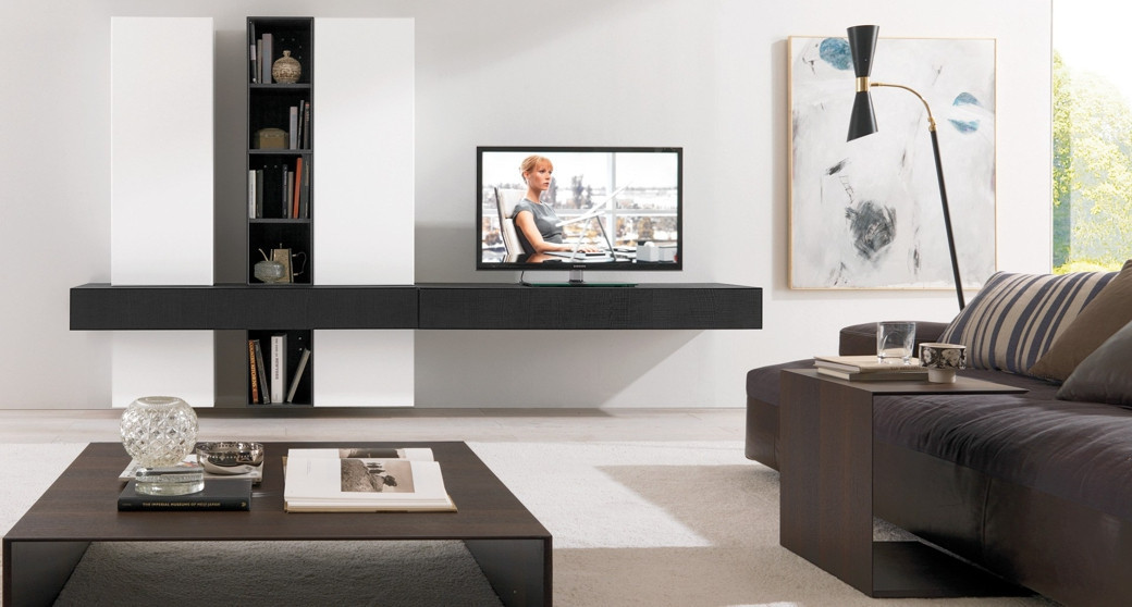 Modern living room with a wall-mounted black and white custom TV unit, flat-screen TV, dark wood coffee and side tables.