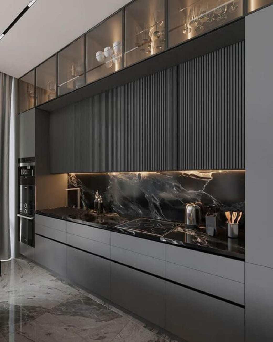 Modern kitchen with matte grey cabinets, black marble countertop and backsplash, LED strip lighting under upper cabinets.