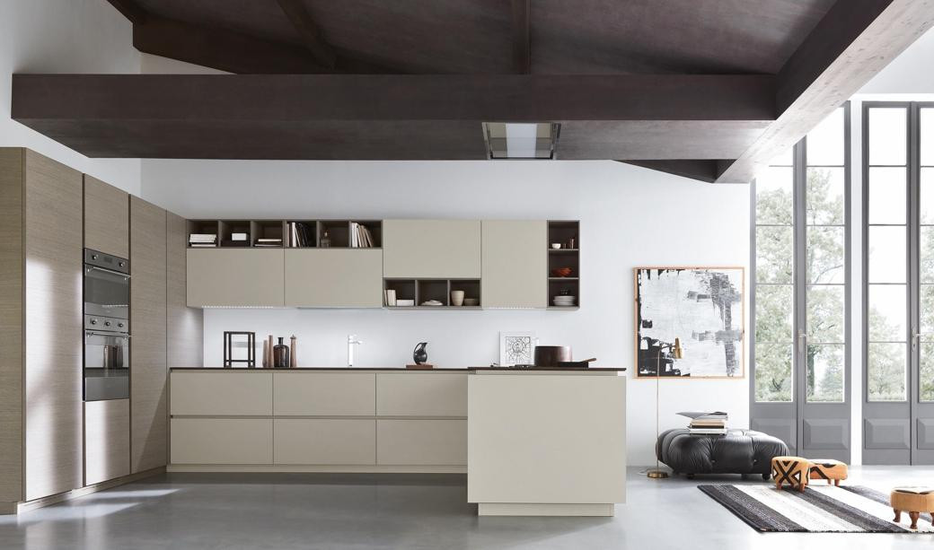 Modern kitchen with beige and wood cabinetry, built-in ovens, open shelving, black countertop, and large windows.