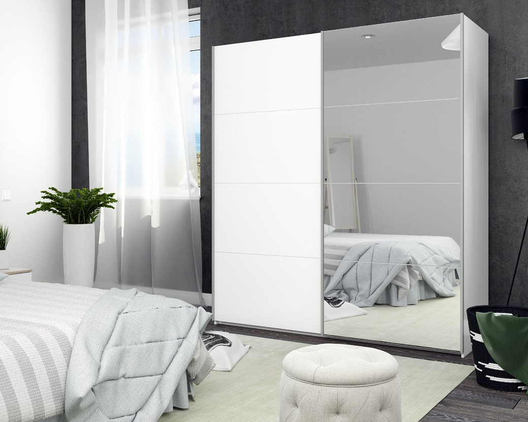 Bedroom with a white sliding door cupboard, one door mirrored, light bedding, potted plant, sheer curtains, and a small round