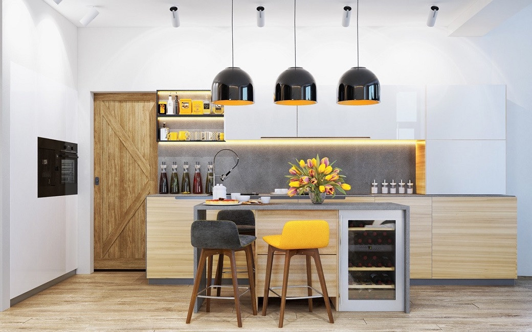 Modern kitchen with wooden cabinets, three black pendant lights, a kitchen island with grey and yellow stools, and a bouquet