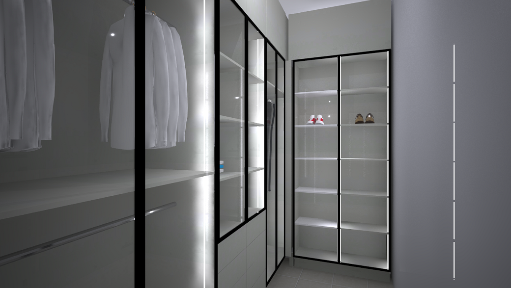 Walk-in closet with frosted glass doors, hanging white shirts, shelving with shoes, and soft lighting.