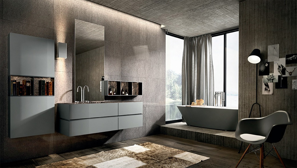 Modern bathroom with grey wall-mounted vanity units, large mirror, freestanding bathtub by window, chair, and contemporary li